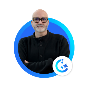 Portrait of a bald man with glasses wearing a black jumper inside a blue circular frame.